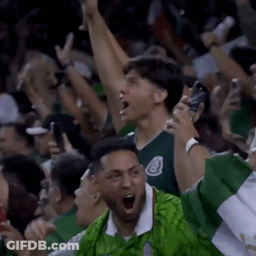 Man In Green Shirt Cheering In Crowd GIF