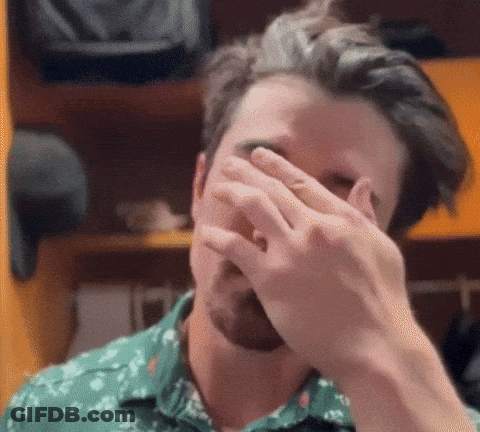 Man In Green Shirt Covering Face GIF