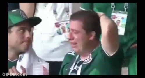 Man In Green Shirt Crying In Stadium With Onlooker GIF