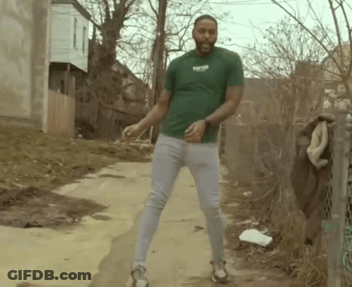 Man In Green Shirt Dancing On Dirt Road GIF
