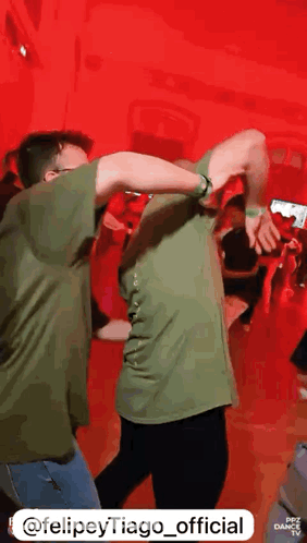 Man In Green Shirt Dancing With Another Man GIF