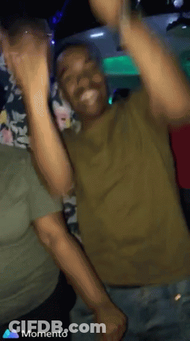 Man In Green Shirt Dancing With Hands Up Saying Momento GIF