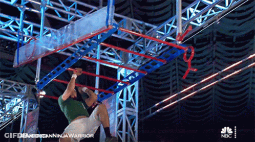 Man In Green Shirt Doing Ninja Warrior GIF
