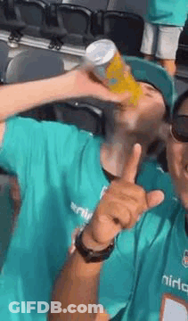 Man In Green Shirt Drinking Can And Thumbs Up GIF