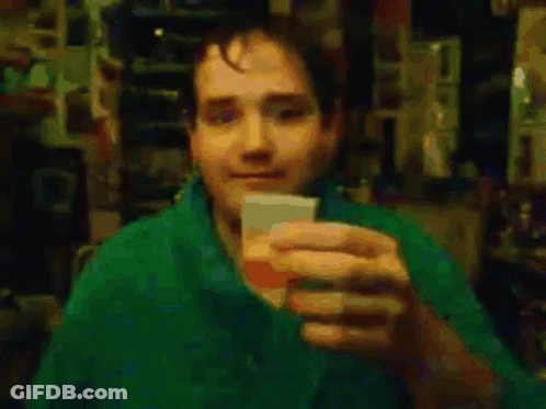 Man In Green Shirt Drinking From Cup GIF