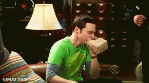 Man In Green Shirt Eating Bag Of Food GIF
