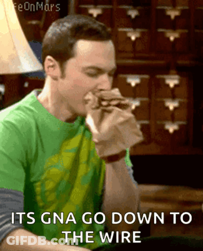 Man In Green Shirt Eating Sandwich Its Gna Go Down To The Wire GIF