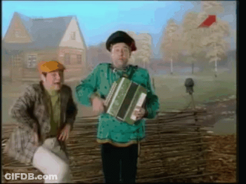 Man In Green Shirt Holding Accordion GIF