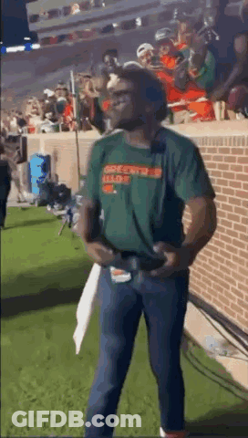 Man In Green Shirt Holding Football GIF
