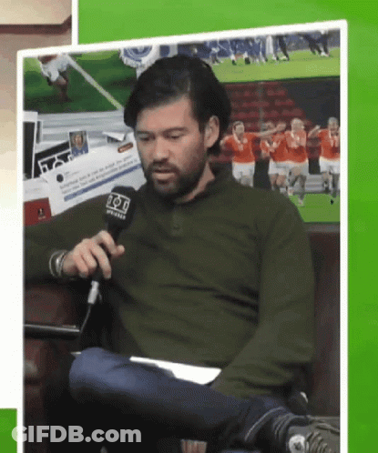 Man In Green Shirt Holding Fox Microphone GIF