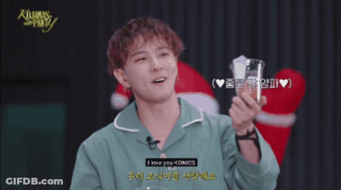 Man In Green Shirt Holding Glass Saying Merry Christmas GIF