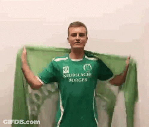 Man In Green Shirt Holding Green Scarf GIF