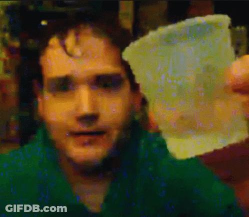 Man In Green Shirt Holding Plastic GIF