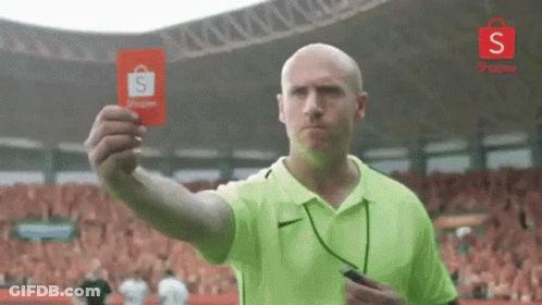 Man In Green Shirt Holding Red Card To Crowd GIF