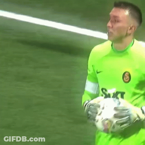 Man In Green Shirt Holding Soccer Ball GIF