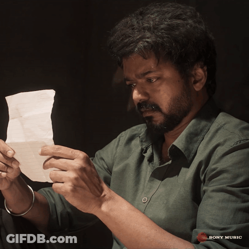 Man In Green Shirt Holding Sony Music Paper GIF