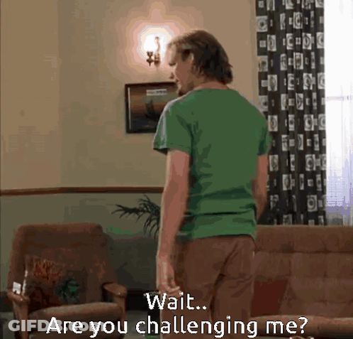 Man In Green Shirt In Living Room Saying Wait Are You Challenging Me GIF