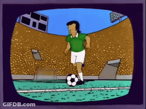 Man In Green Shirt Kicking Soccer Ball GIF