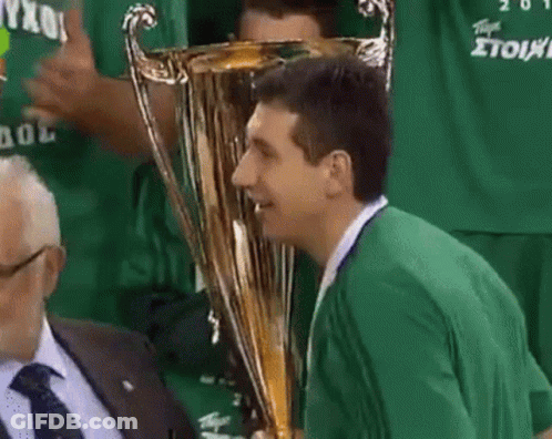 Man In Green Shirt Kissing Gold Trophy GIF