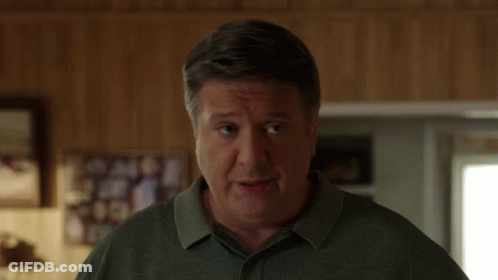 Man In Green Shirt Looking GIF
