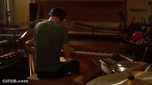 Man In Green Shirt Playing Piano GIF