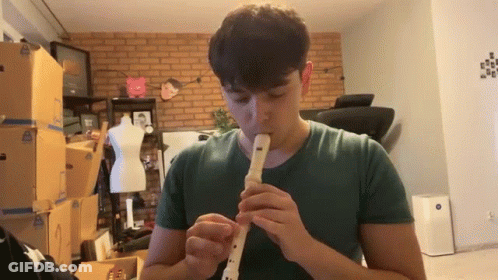 Man In Green Shirt Playing Recorder GIF
