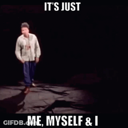 Man In Green Shirt Pointing At Another In Dark Room GIF