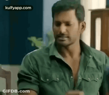 Man In Green Shirt Sitting In Chair GIF