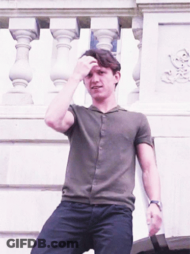 Man In Green Shirt Sitting On Balcony GIF