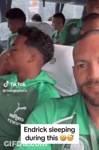Man In Green Shirt Sleeping On Bus With Others GIF