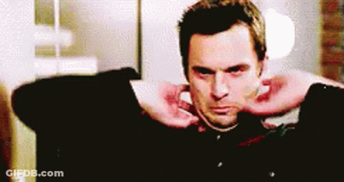 Man In Green Shirt Smiling At Man In Red GIF