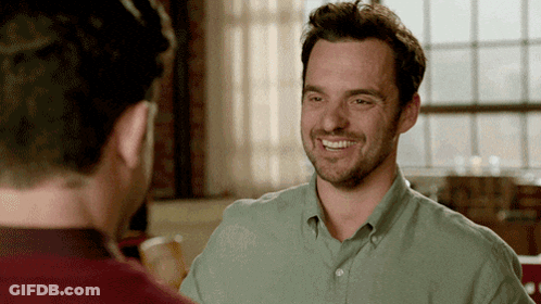 Man In Green Shirt Smiling At Man In Red Shirt GIF