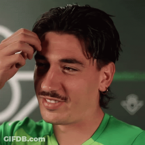 Man In Green Shirt Smiling In Front Of Crown GIF