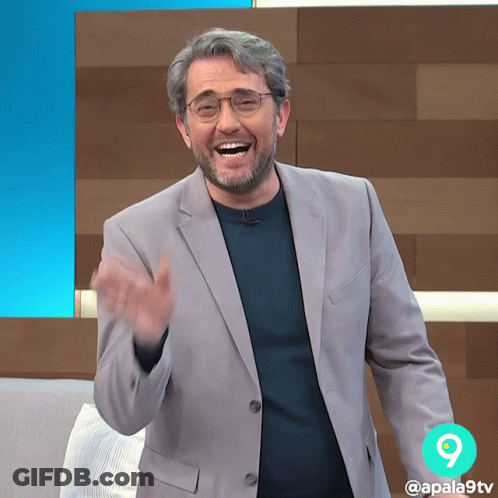 Man In Green Shirt Smiling In Front Of Monster GIF