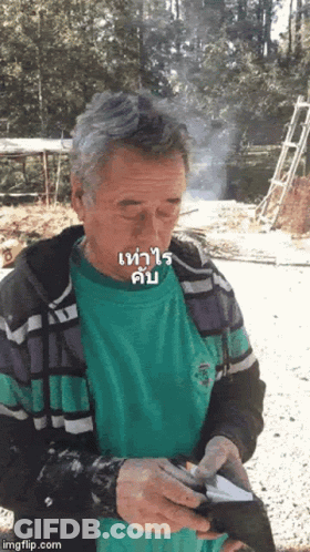 Man In Green Shirt Smoking Cigarette Holding Wallet GIF