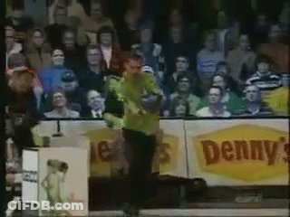 Man In Green Shirt Standing In Front Of Denny's Sign GIF