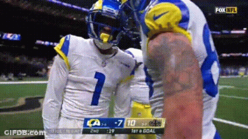 Man In Green Shirt Standing In Front Of Ohhhhhhh Sign GIF