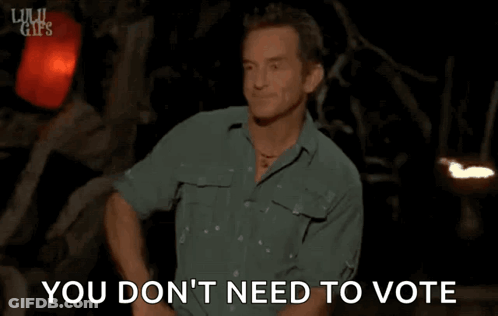 Man In Green Shirt Standing In Front Of Sign Saying You Don't Need To Vote GIF
