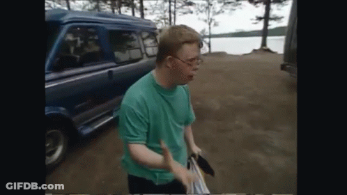 Man In Green Shirt Standing In Front Of Van GIF
