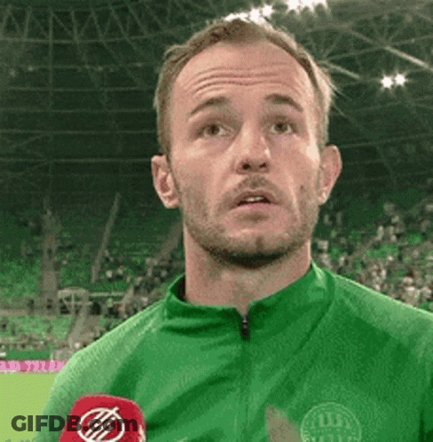 Man In Green Shirt Talking Into Microphone GIF
