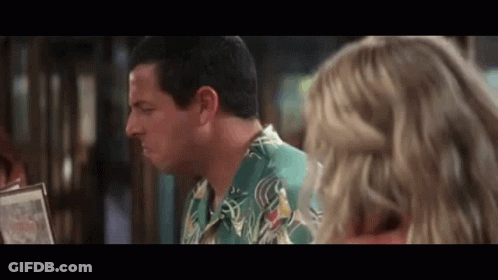 Man In Green Shirt Talking To Woman Over Menu GIF