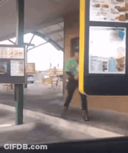 Man In Green Shirt Walking Through Drive-Thru GIF
