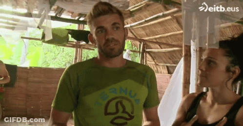 Man In Green Shirt With Nua Next To Woman GIF