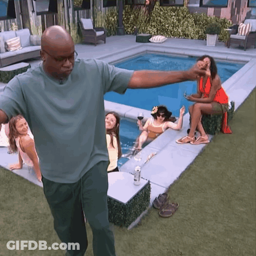 Man In Green Shirt With Women On Pool Edge GIF
