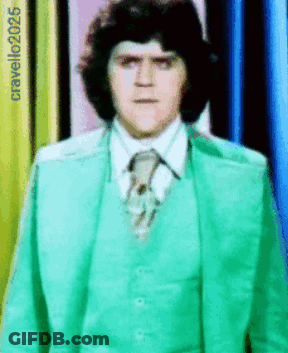Man In Green Suit And Tie In Front Of Cravello2025 Sign GIF