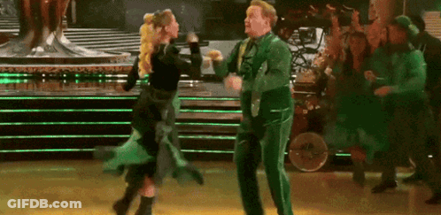Man In Green Suit Dancing With Woman In Black Dress GIF