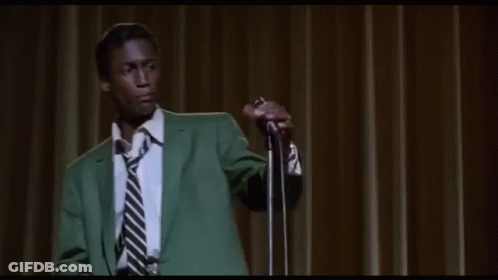 Man In Green Suit Singing Into Microphone GIF