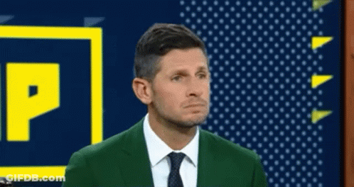 Man In Green Suit Standing Beside P Sign GIF