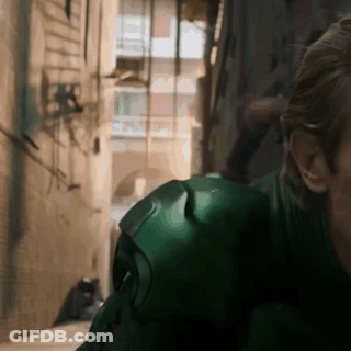 Man In Green Suit Standing In Alleyway GIF