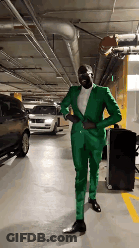 Man In Green Suit Standing In Garage GIF